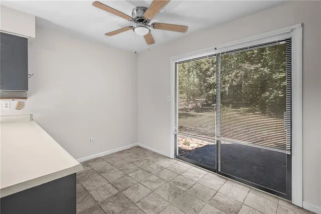 a view of a livingroom with a ceiling fan and window