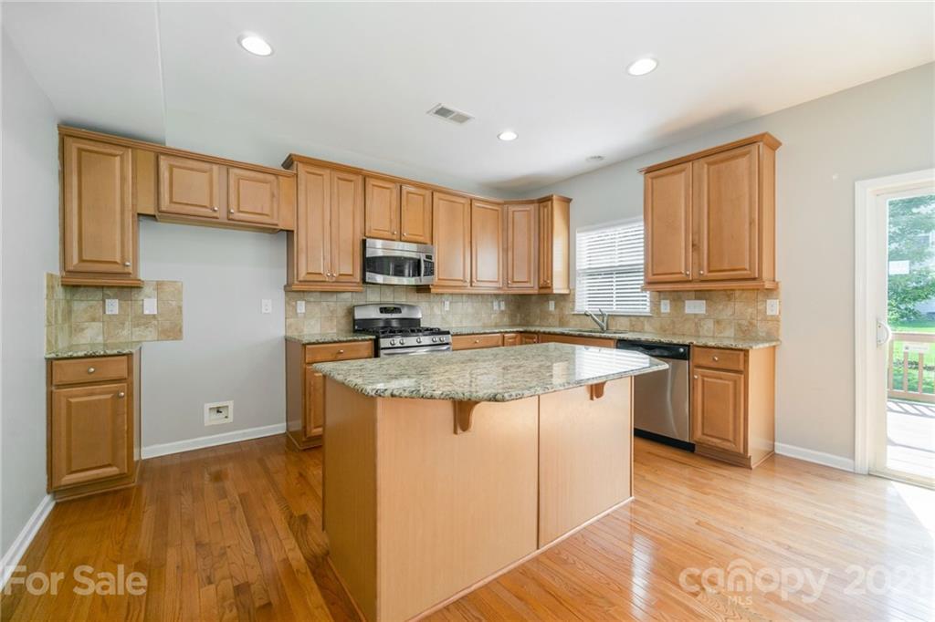 244 Lorraine Road Fort Mill, SC 29708 - Photo 2 of 33 a kitchen with stainless steel appliances granite countertop a stove a sink dishwasher and a refrigerator