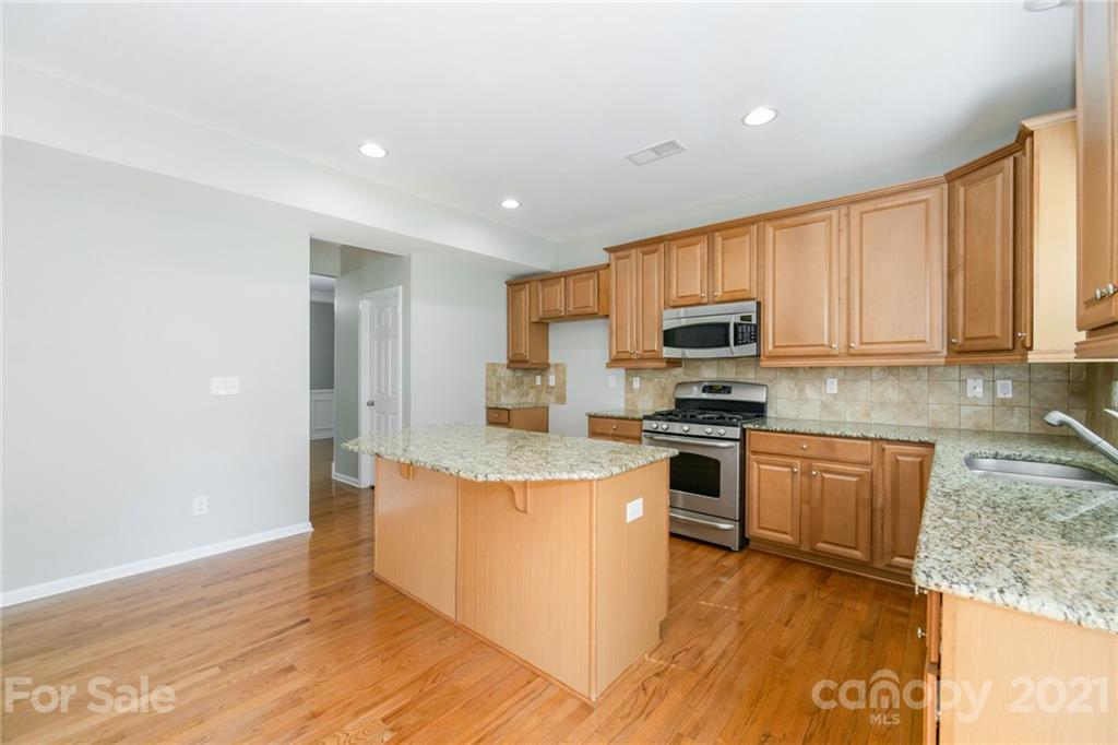 244 Lorraine Road Fort Mill, SC 29708 - Photo 3 of 33 a kitchen with stainless steel appliances granite countertop a stove a sink and a refrigerator
