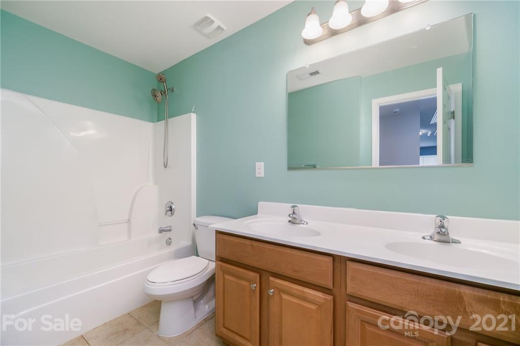 244 Lorraine Road Fort Mill, SC 29708 - Photo 22 of 33 a bathroom with a sink a toilet and a large mirror