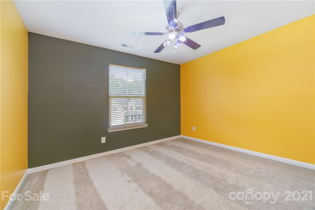 244 Lorraine Road Fort Mill, SC 29708 - Photo 27 of 33 a bedroom with a bed and a chandelier