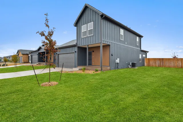 a front view of a house with a garden and yard