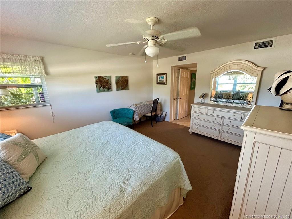 2950 Southeast Ocean Boulevard, Unit 546 Stuart, FL 34996 - Photo 16 of 33 a bedroom with a large bed and a large window