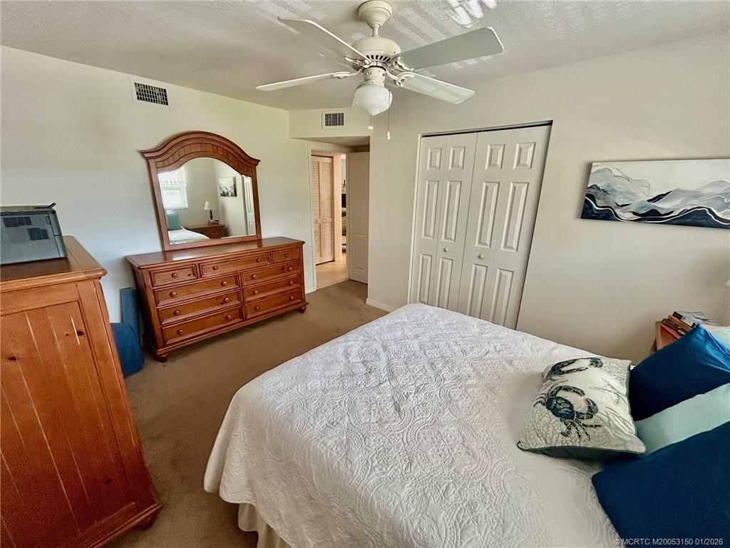 2950 Southeast Ocean Boulevard, Unit 546 Stuart, FL 34996 - Photo 19 of 33 a bedroom with a bed and a dresser