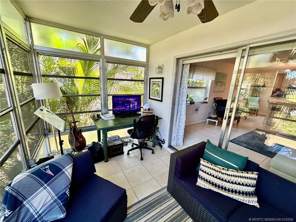 2950 Southeast Ocean Boulevard, Unit 546 Stuart, FL 34996 - Photo 22 of 33 a living room with furniture a piano and a window