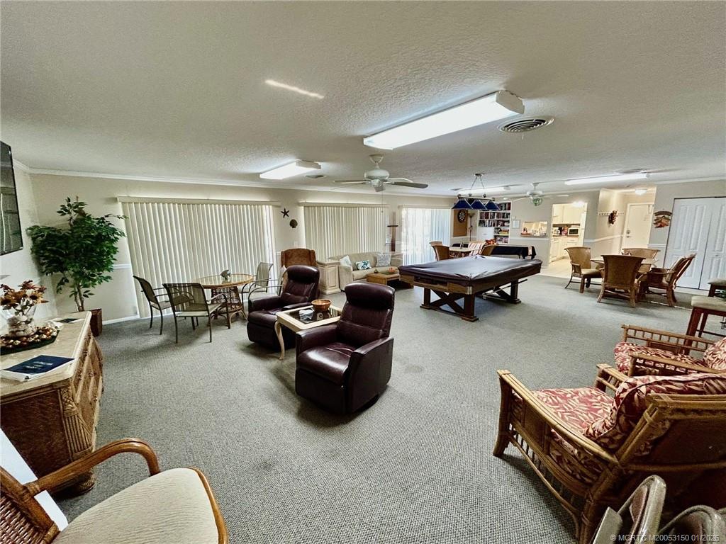 2950 Southeast Ocean Boulevard, Unit 546 Stuart, FL 34996 - Photo 28 of 33 a living room with furniture kitchen view and a table