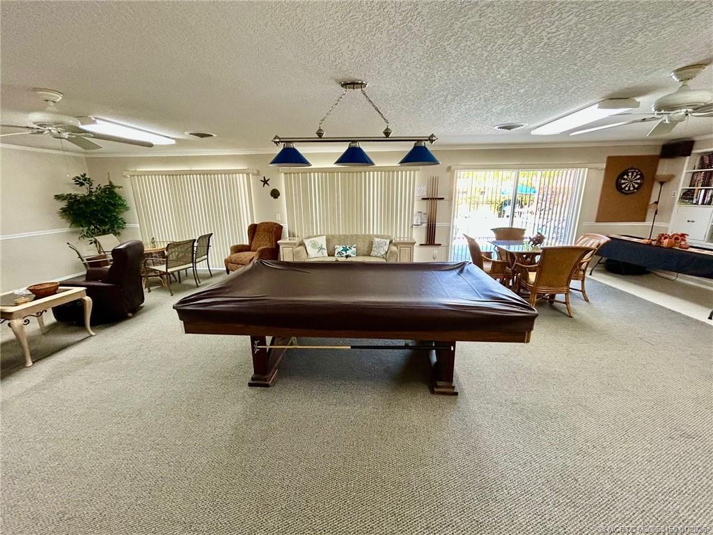 2950 Southeast Ocean Boulevard, Unit 546 Stuart, FL 34996 - Photo 29 of 33 a living room with furniture pool table and a window