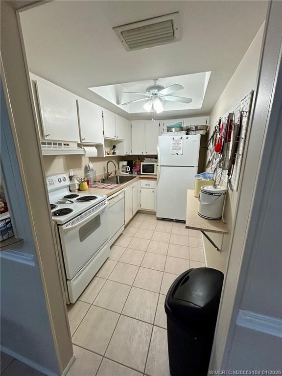 2950 Southeast Ocean Boulevard, Unit 546 Stuart, FL 34996 - Photo 30 of 33 a kitchen with a sink and white cabinets