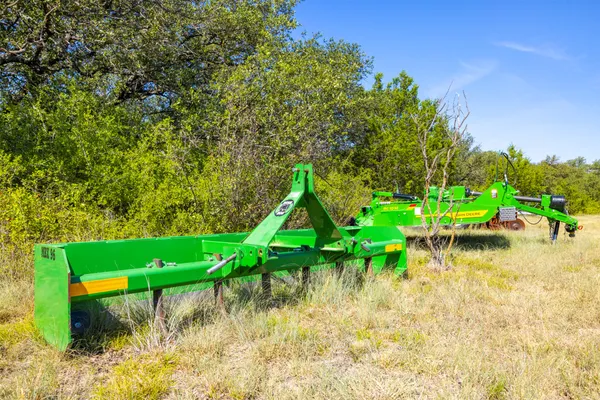 a green field with lots of trees