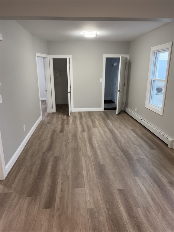 121 Whitman Street, Unit 2 New Bedford, MA 02745 - Photo 4 of 11 a view of an empty room and wooden floor