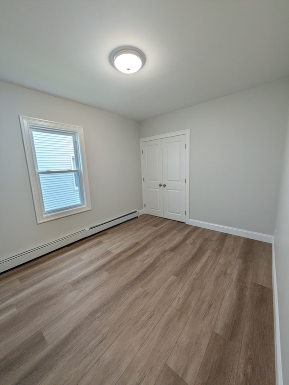 121 Whitman Street, Unit 2 New Bedford, MA 02745 - Photo 6 of 11 a view of empty room with wooden floor and fan