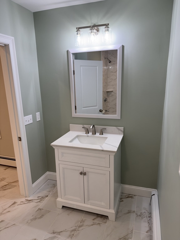 121 Whitman Street, Unit 2 New Bedford, MA 02745 - Photo 8 of 11 a bathroom with a sink and a mirror