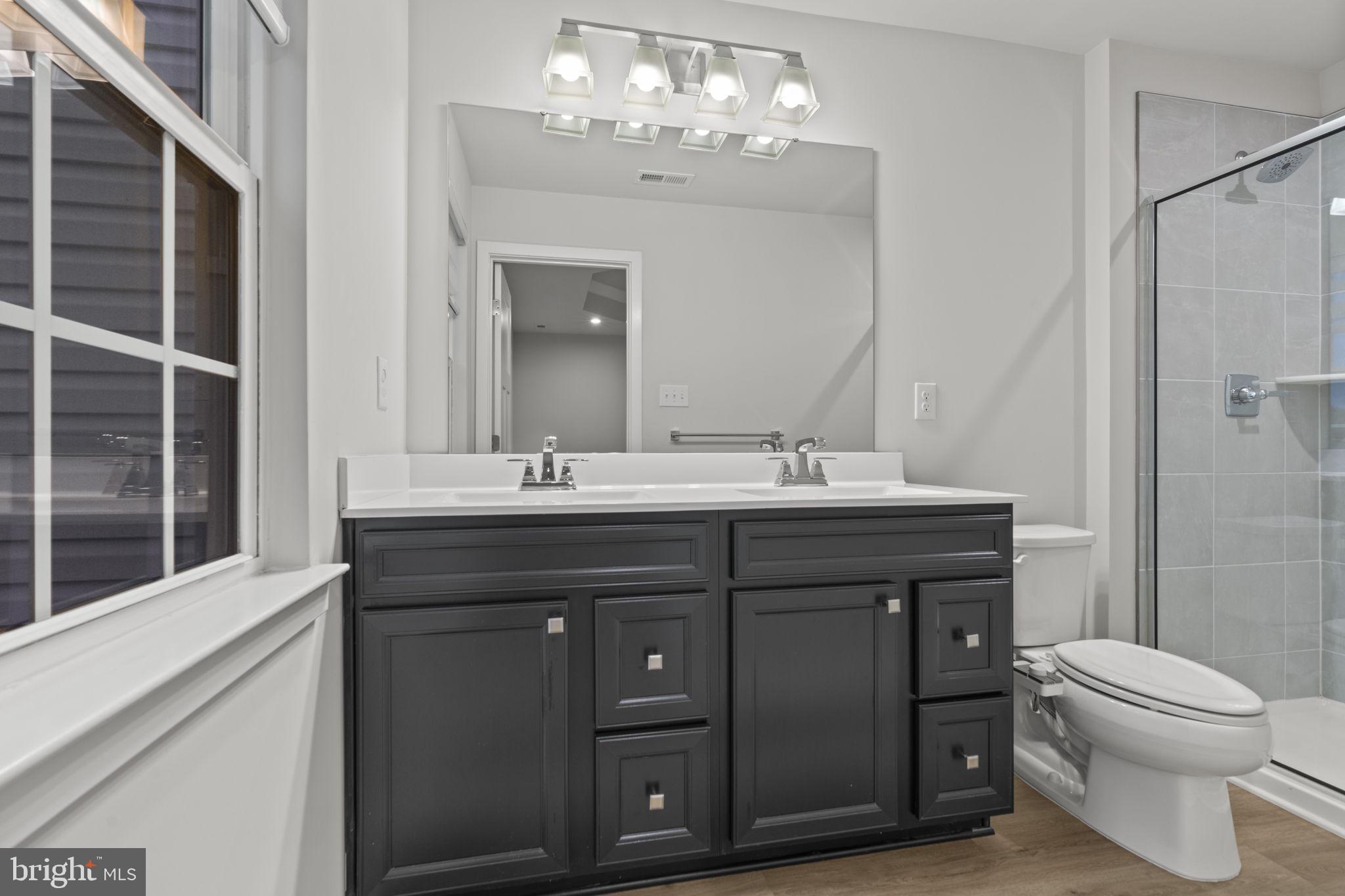 208 Freedom Way Sicklerville, NJ 08081 - Photo 27 of 34 a bathroom with a sink vanity and a toilet