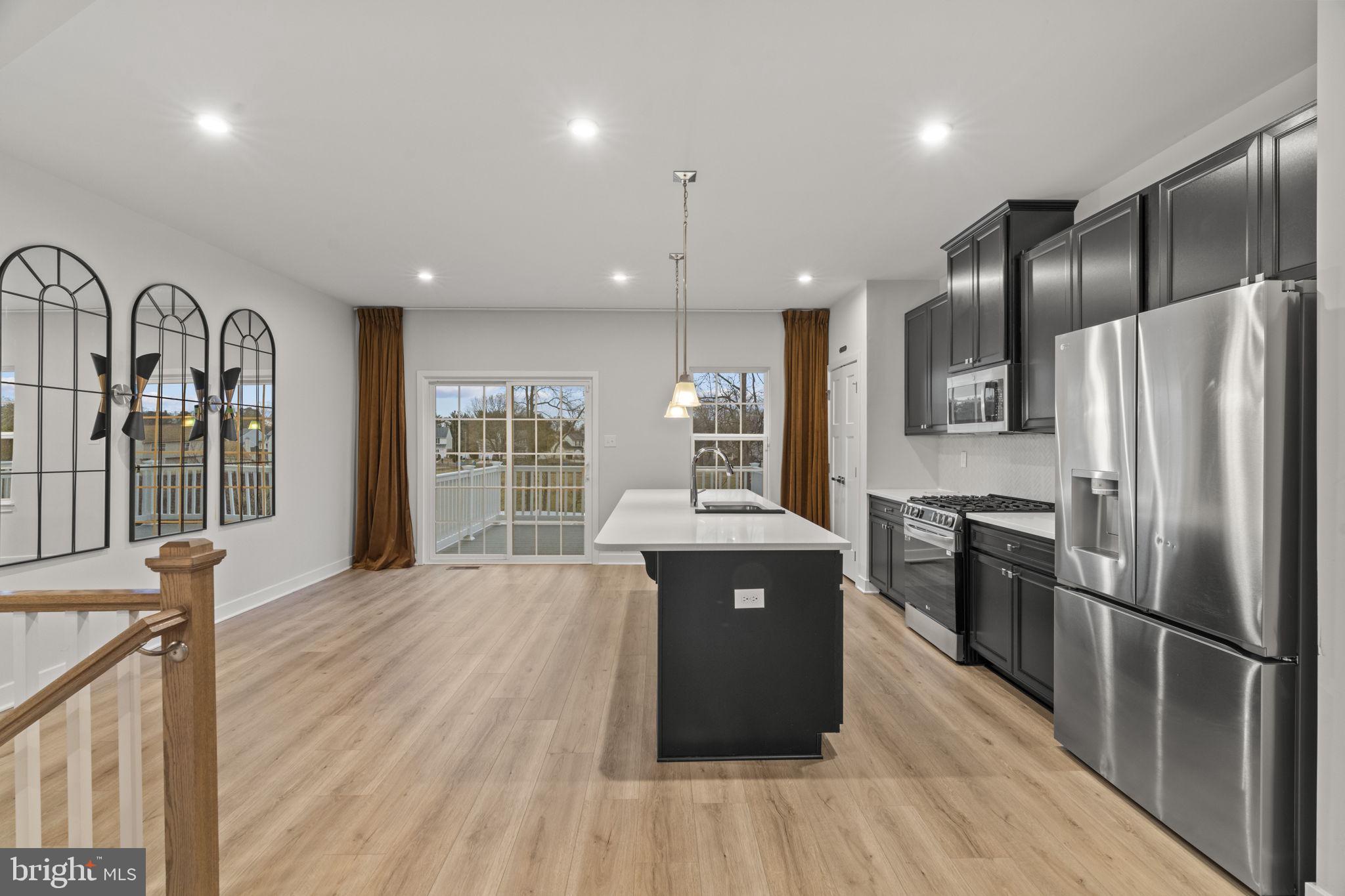 208 Freedom Way Sicklerville, NJ 08081 - Photo 7 of 34 a kitchen with kitchen island a counter top space a sink and stainless steel appliances