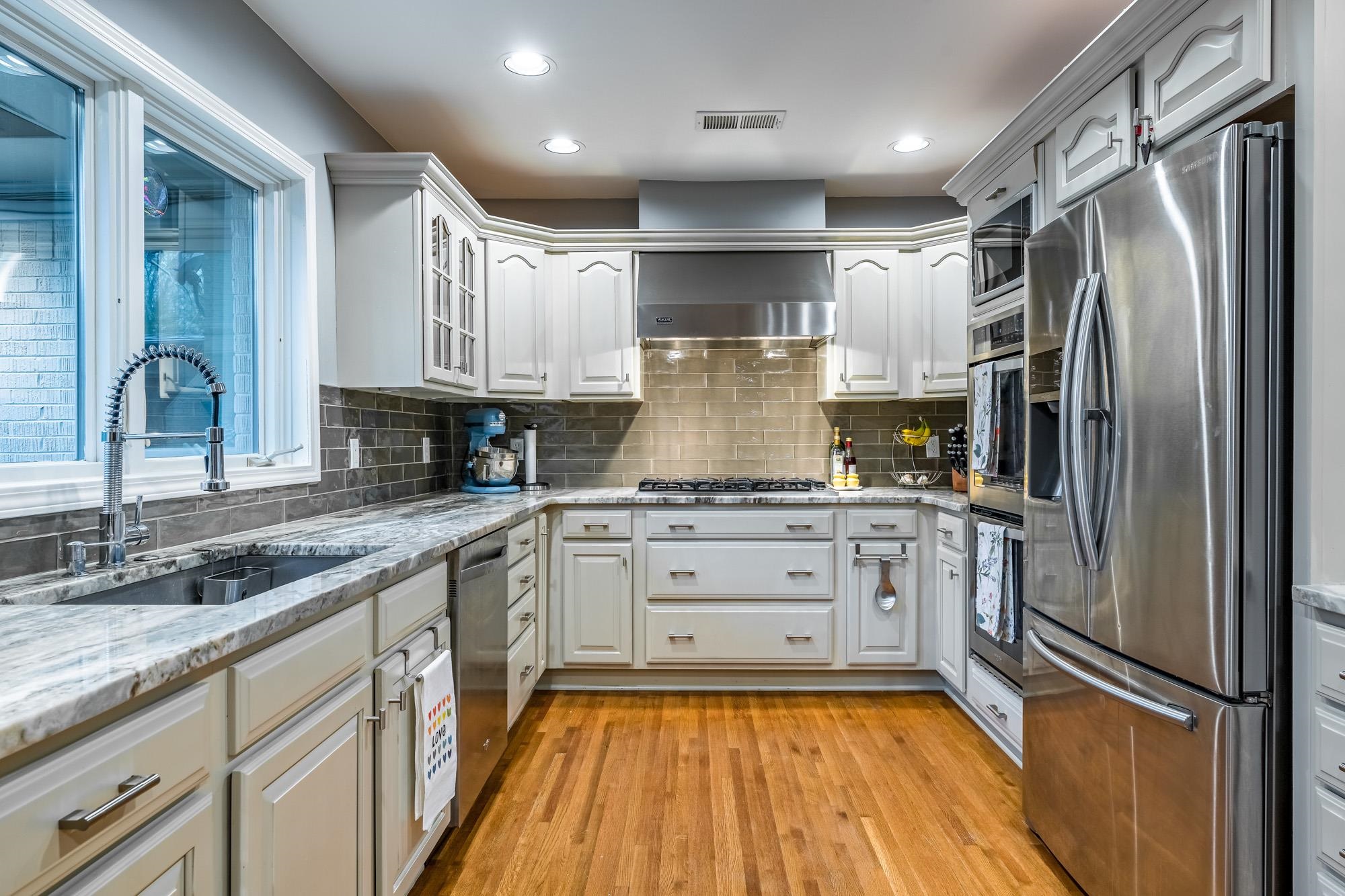 5179 Shady Grove Road Memphis, TN 38117 - Photo 15 of 25 a kitchen with stainless steel appliances granite countertop a refrigerator sink and white cabinets