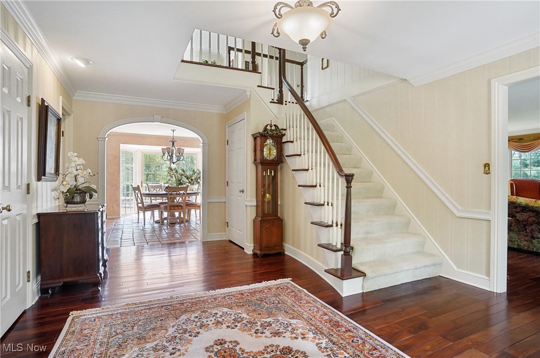 4432 Ira Road Akron, OH 44333 - Photo 3 of 50 Foyer entrance with arched walkways, hardwood / wood-style flooring, a chandelier, healthy amount of natural light, and ornamental molding