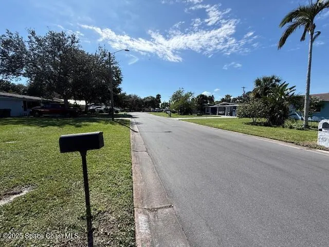 a view of road with grass and a trees