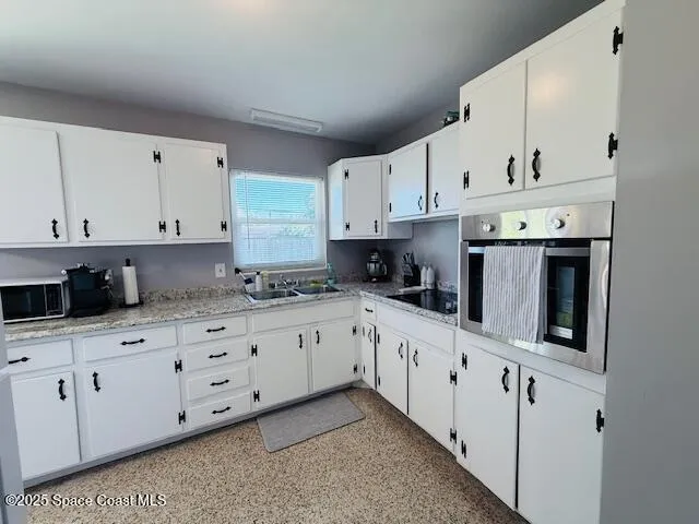 a kitchen with cabinets and refrigerator