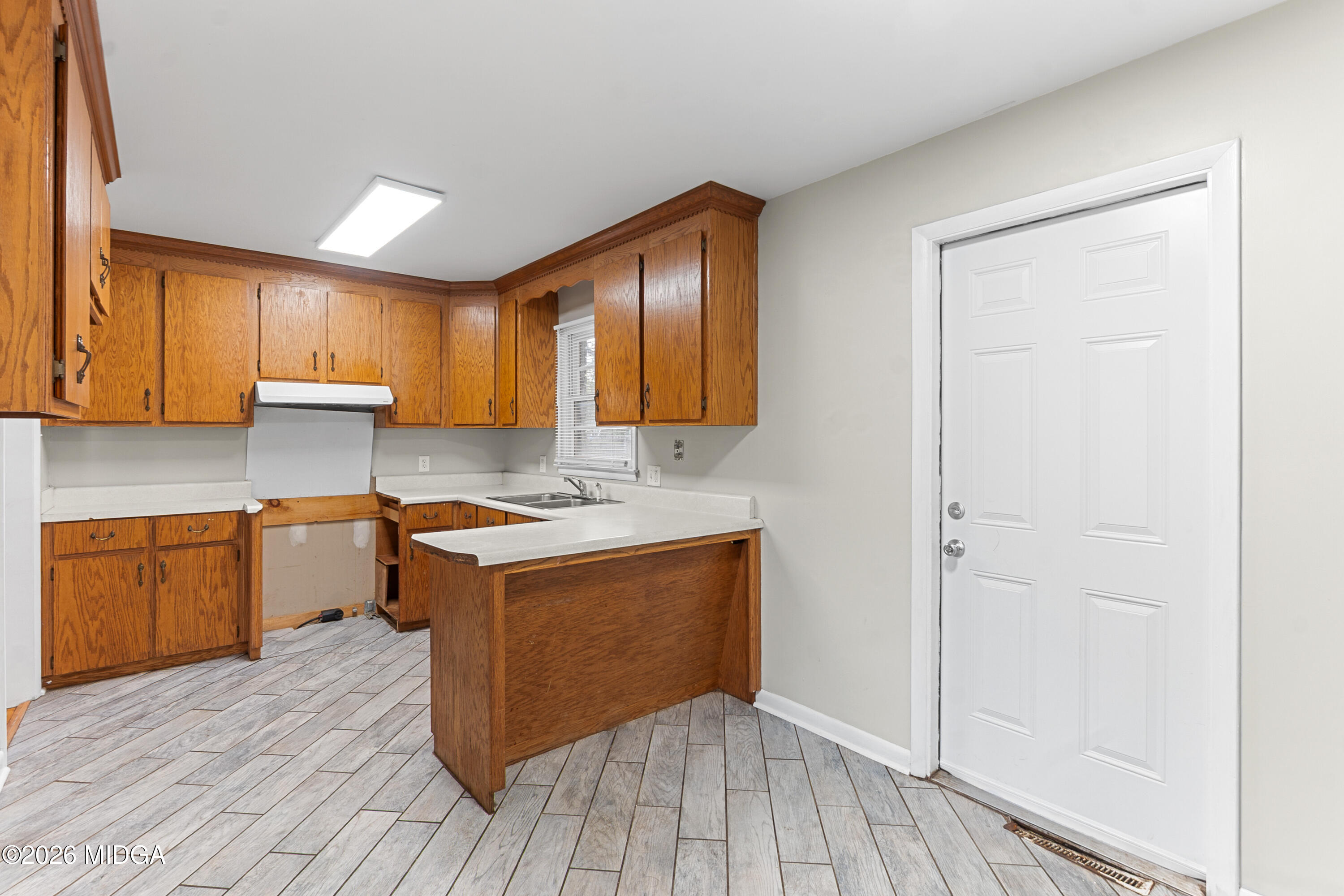 112 Athens Street Warner Robins, GA 31088 - Photo 11 of 42 a kitchen with a sink cabinets and wooden floor