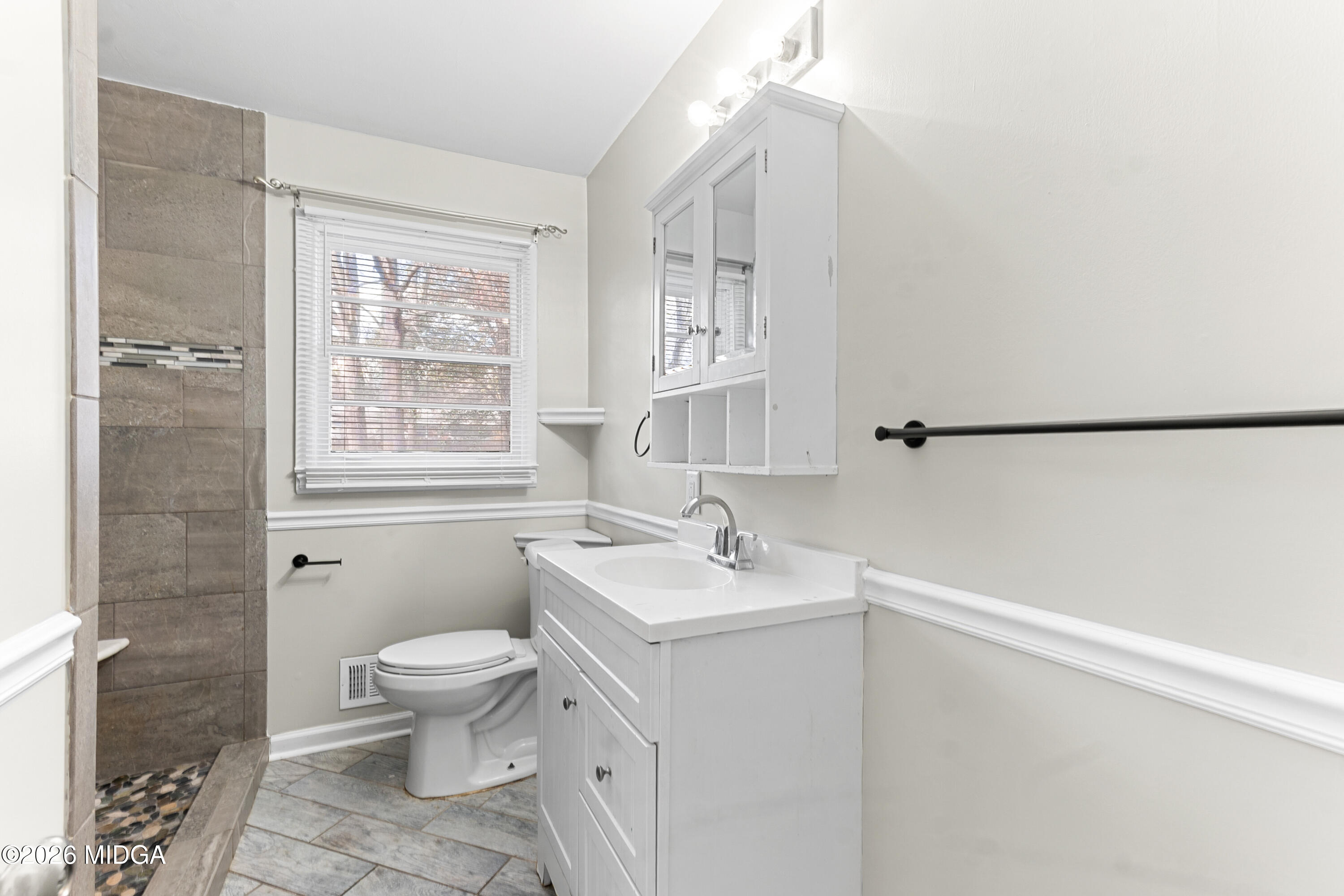 112 Athens Street Warner Robins, GA 31088 - Photo 15 of 42 a bathroom with a sink toilet and shower