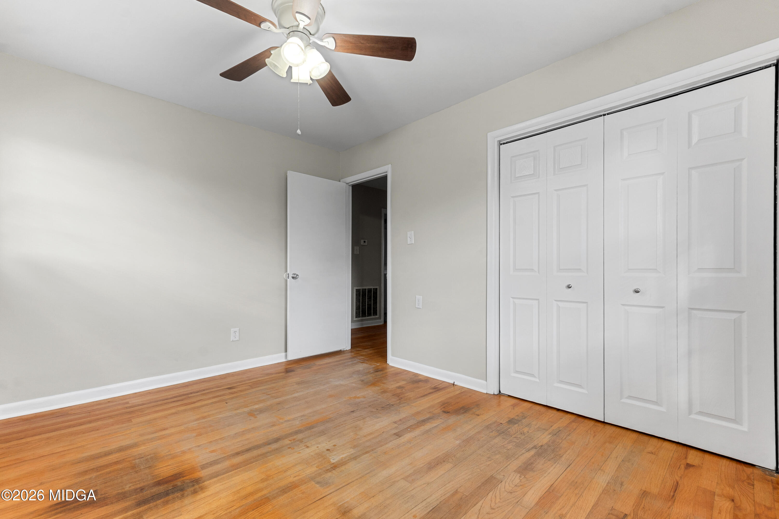 112 Athens Street Warner Robins, GA 31088 - Photo 19 of 42 a view of an empty room with wooden floor