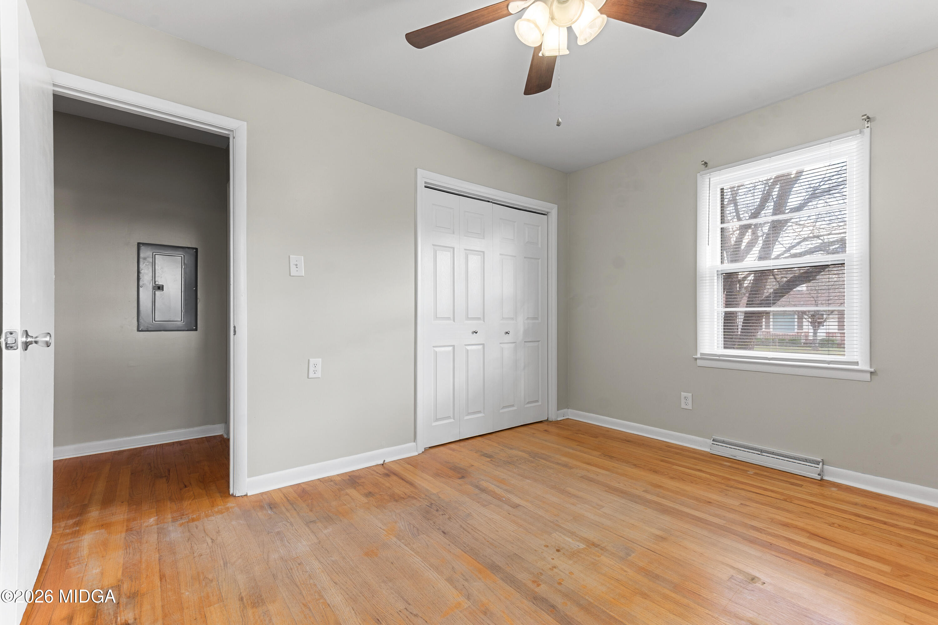 112 Athens Street Warner Robins, GA 31088 - Photo 20 of 42 an empty room with wooden floor chandelier fan and windows