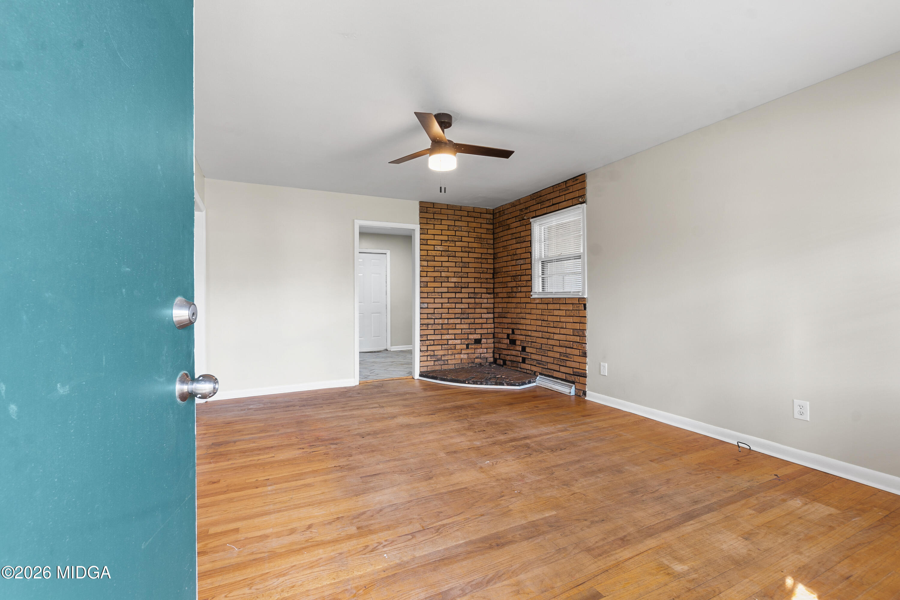 112 Athens Street Warner Robins, GA 31088 - Photo 2 of 42 wooden floor in an empty room with a window
