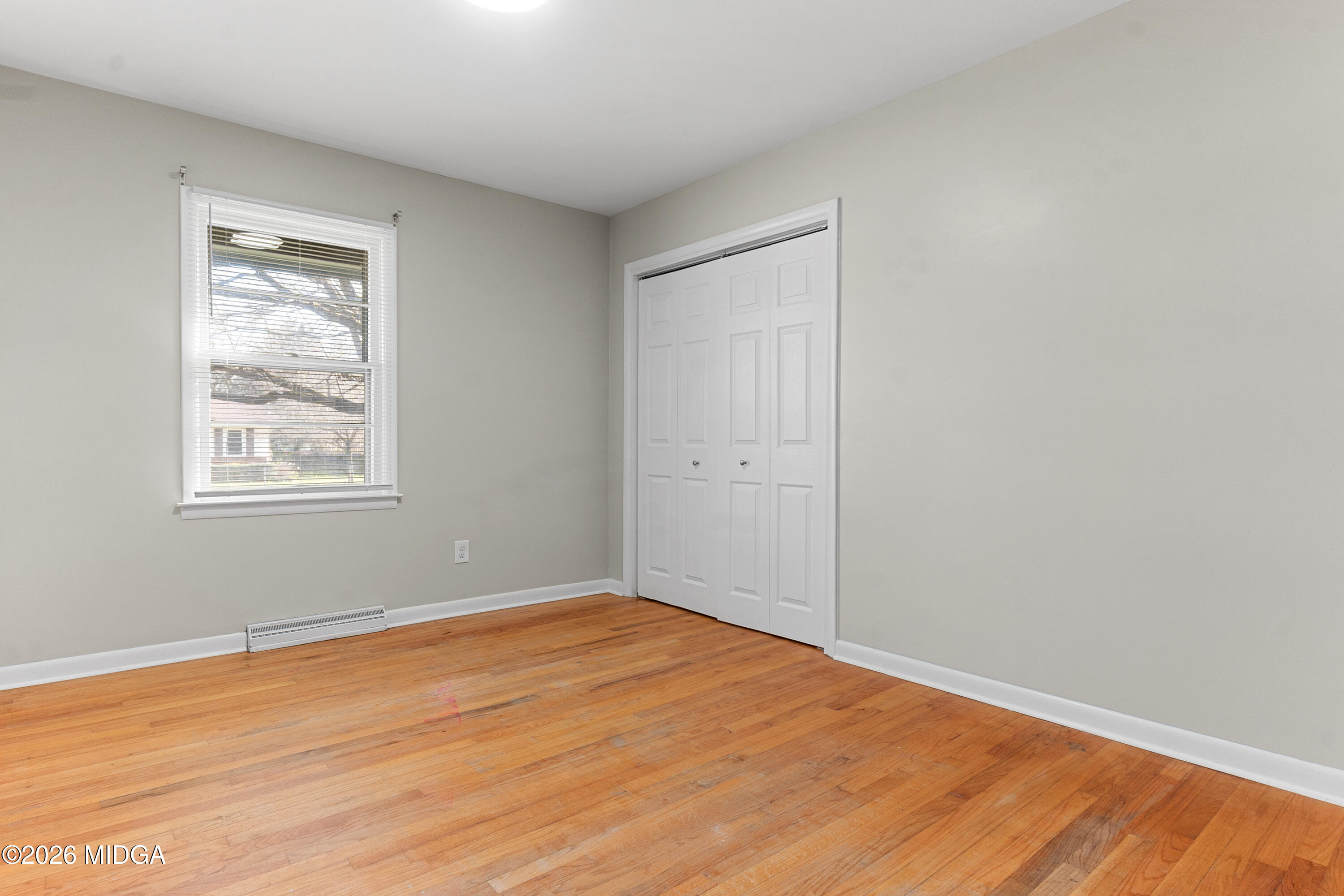 112 Athens Street Warner Robins, GA 31088 - Photo 23 of 42 a view of empty room with wooden floor and fan