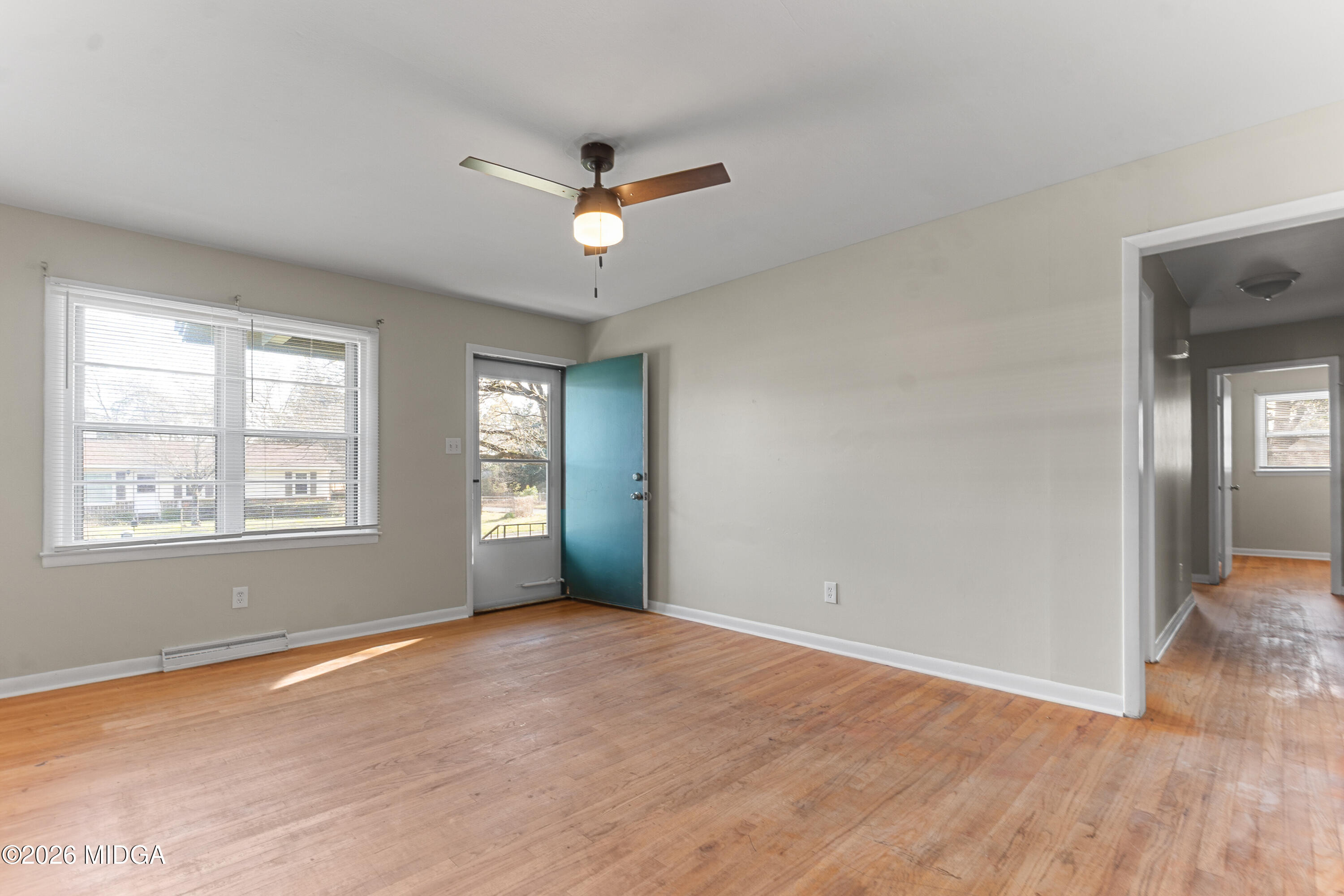 112 Athens Street Warner Robins, GA 31088 - Photo 5 of 42 a view of an empty room with wooden floor and a window