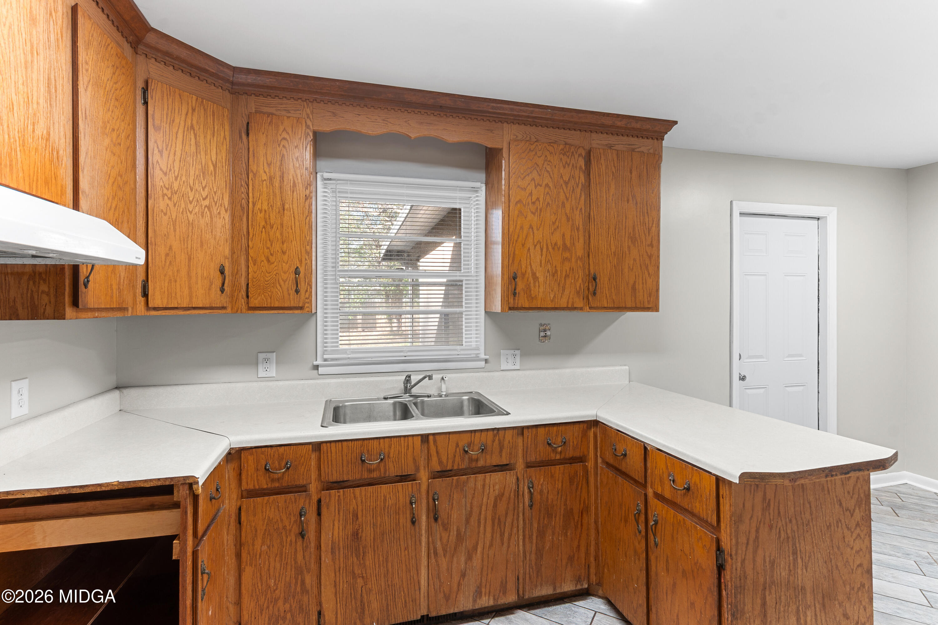 112 Athens Street Warner Robins, GA 31088 - Photo 7 of 42 a kitchen with stainless steel appliances sink cabinets and window