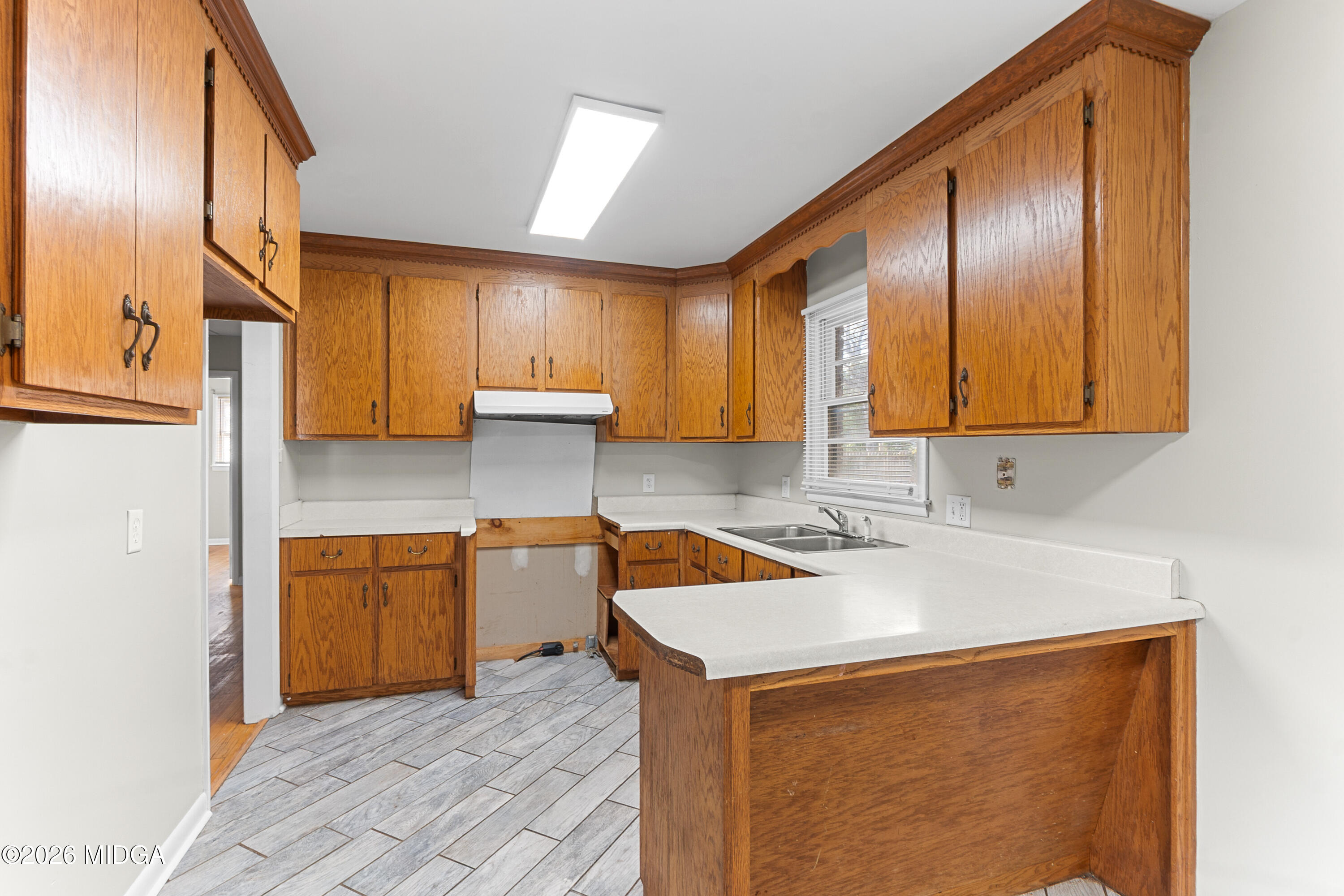 112 Athens Street Warner Robins, GA 31088 - Photo 10 of 42 a kitchen with stainless steel appliances granite countertop a sink a stove and a refrigerator with wooden floor