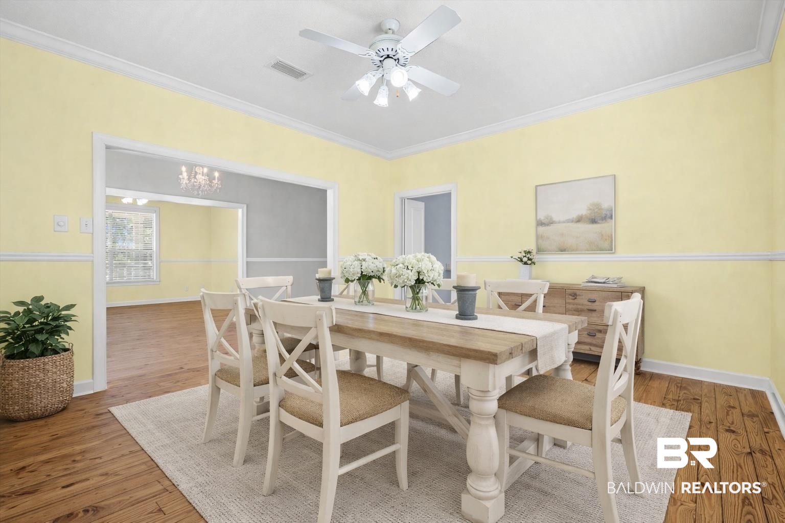 7650 Iron Rush Road Wilmer, AL 36587 - Photo 13 of 34 Dining Space Virtually Staged featuring hardwood floors, a chandelier, crown molding, and a ceiling fan