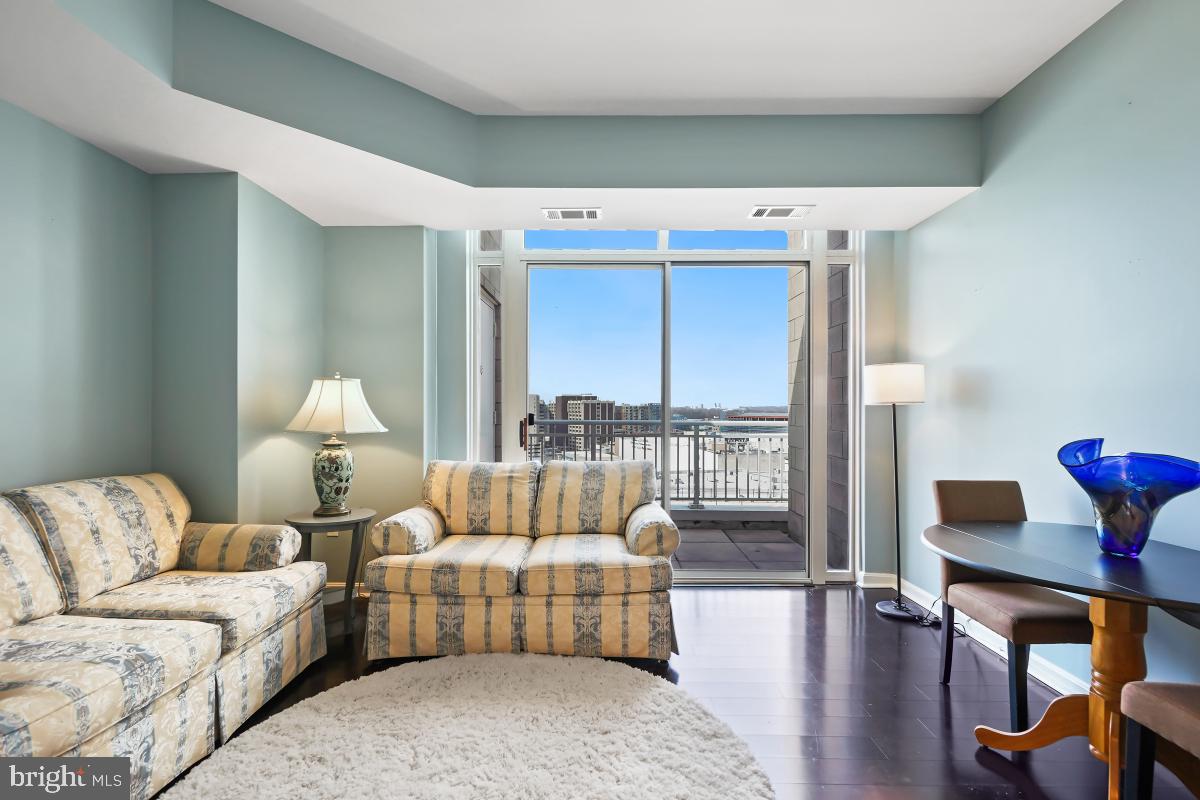 930 Wayne Avenue, Unit 1407 Silver Spring, MD 20910 - Photo 11 of 31 a living room with furniture and a window