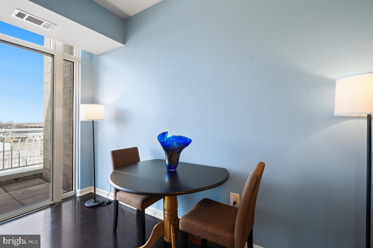 930 Wayne Avenue, Unit 1407 Silver Spring, MD 20910 - Photo 14 of 31 a view of a room with a table and chairs