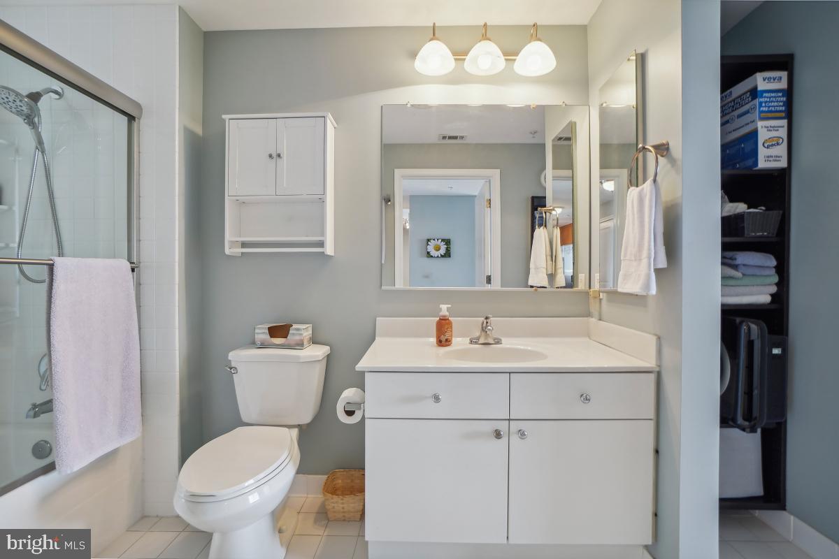 930 Wayne Avenue, Unit 1407 Silver Spring, MD 20910 - Photo 26 of 31 a bathroom with a sink toilet vanity and shower