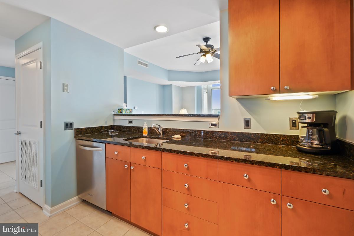 930 Wayne Avenue, Unit 1407 Silver Spring, MD 20910 - Photo 6 of 31 a kitchen with granite countertop stainless steel appliances a sink and cabinets