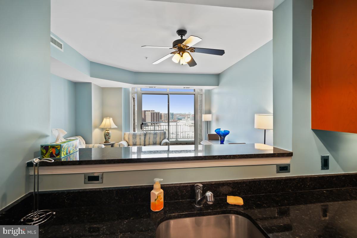 930 Wayne Avenue, Unit 1407 Silver Spring, MD 20910 - Photo 7 of 31 a living room with furniture and a window