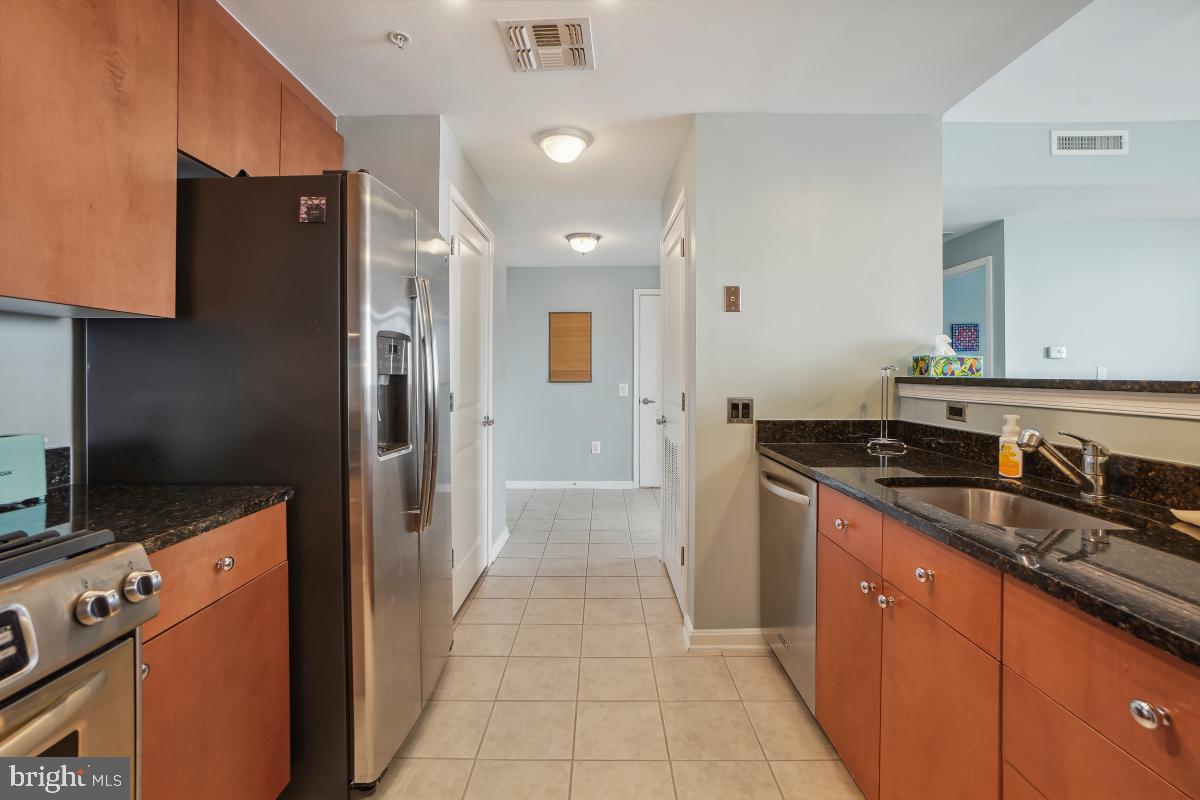 930 Wayne Avenue, Unit 1407 Silver Spring, MD 20910 - Photo 8 of 31 a kitchen with stainless steel appliances granite countertop a refrigerator and a sink