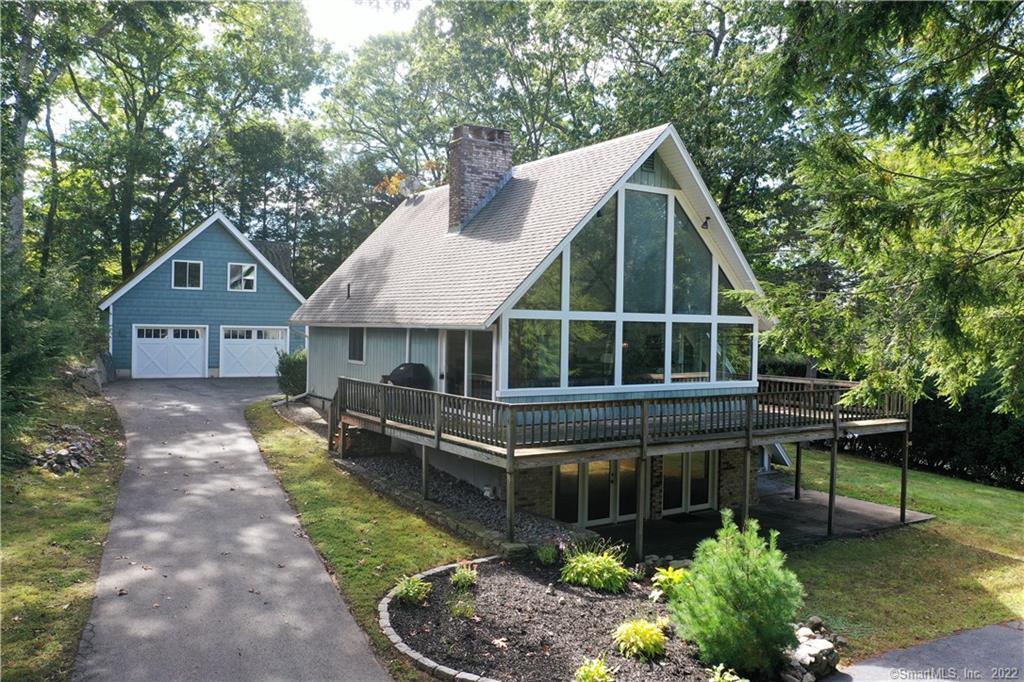 a front view of a house with a yard and potted plants