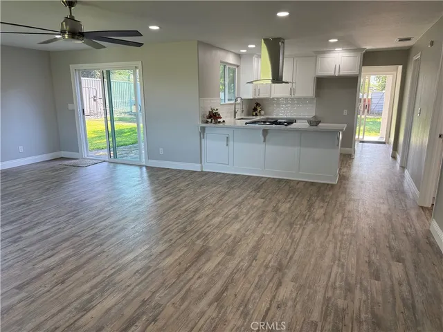 a view of a kitchen with a sink and wooden floor