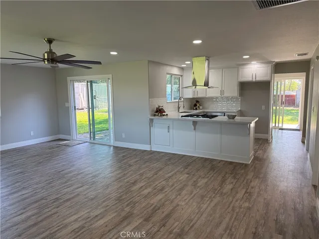 a kitchen with white cabinets sink and window