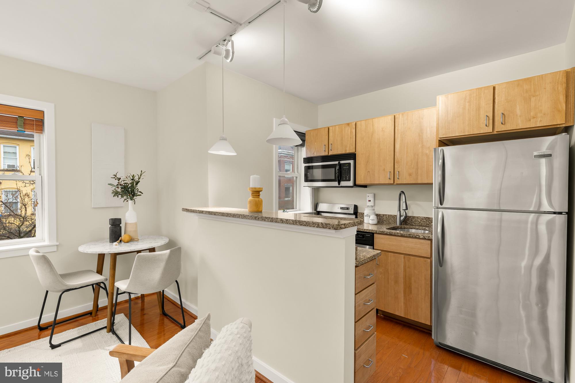 3534 10th Street Northwest, Unit 200 Washington, DC 20010 - Photo 11 of 34 a kitchen with cabinets stainless steel appliances and a refrigerator