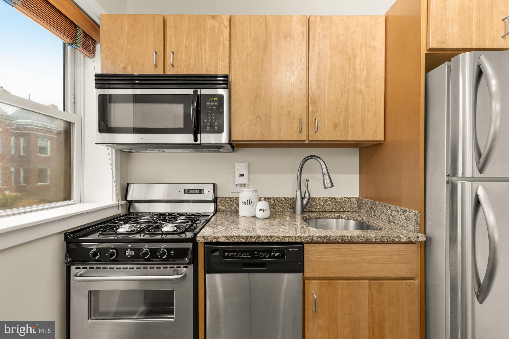 3534 10th Street Northwest, Unit 200 Washington, DC 20010 - Photo 14 of 34 a kitchen with granite countertop a stove sink and refrigerator