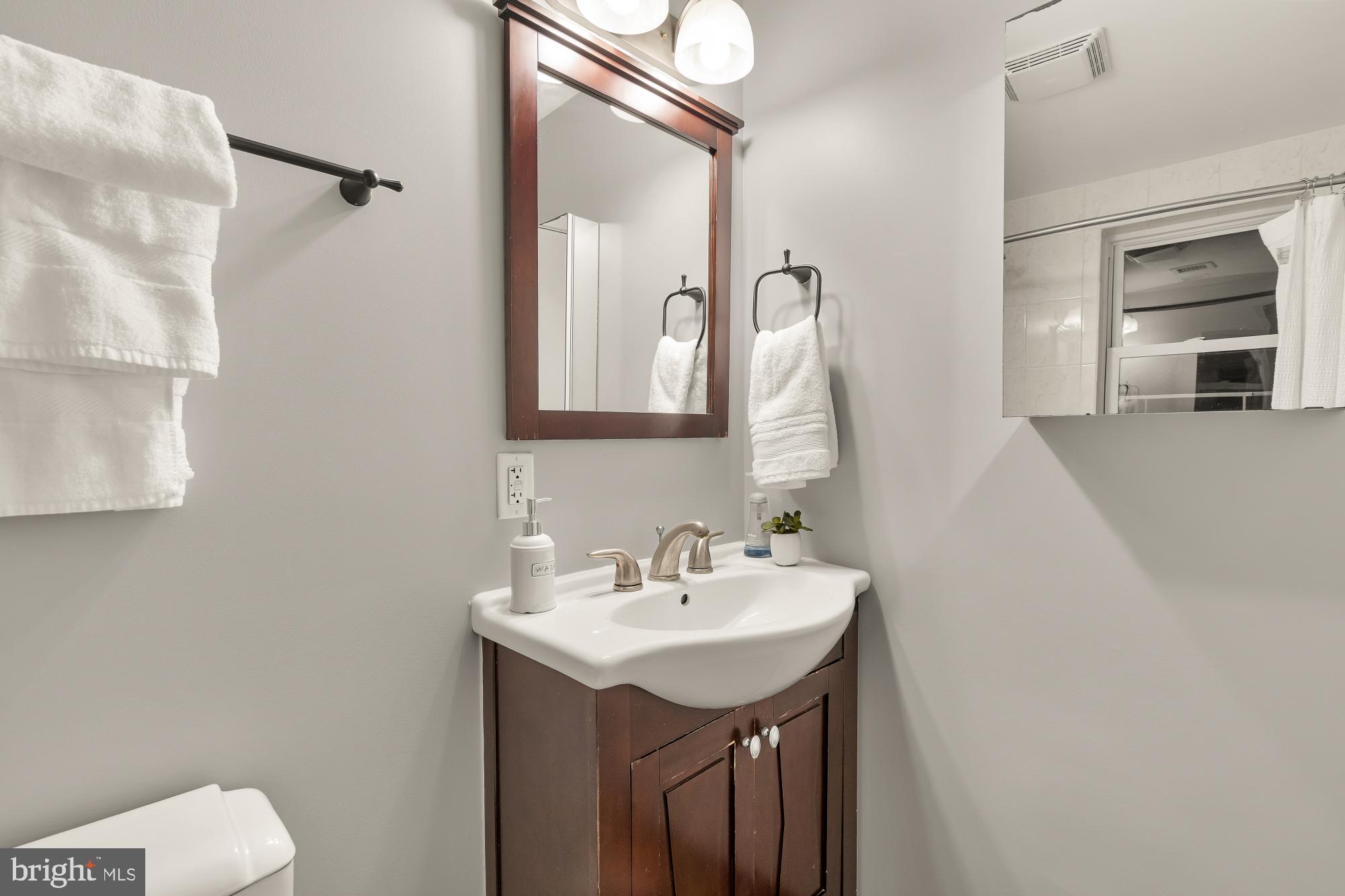 3534 10th Street Northwest, Unit 200 Washington, DC 20010 - Photo 19 of 34 a bathroom with a sink a toilet and a mirror
