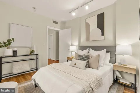 a bedroom with a bed and a potted plant