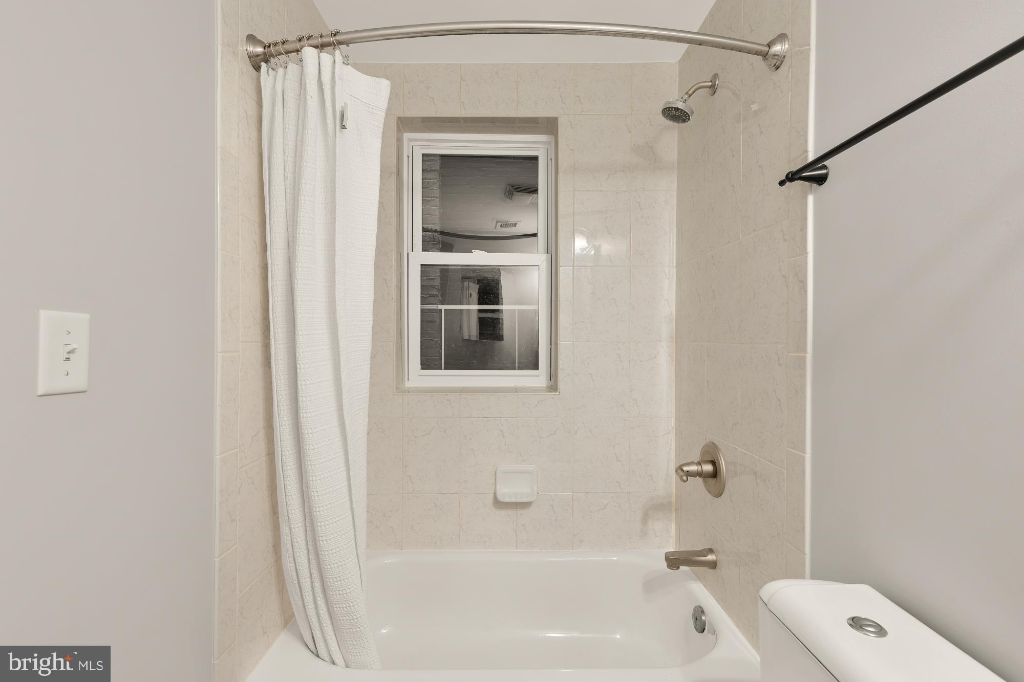 3534 10th Street Northwest, Unit 200 Washington, DC 20010 - Photo 21 of 34 a bathroom with a bathtub shower and toilet