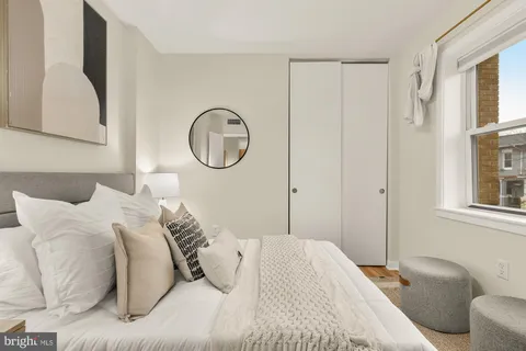 a bedroom with a bed and a window