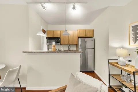 a kitchen with stainless steel appliances granite countertop a refrigerator and a stove