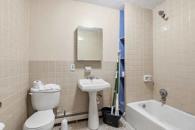 a bathroom with a sink mirror toilet and bathtub