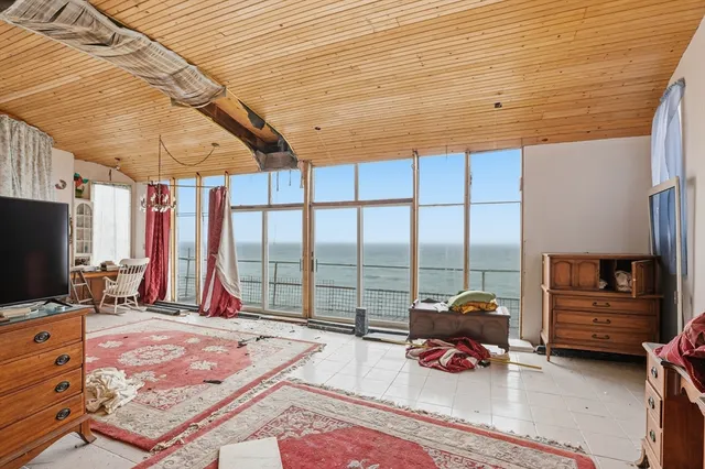 a bedroom with furniture and a flat screen tv